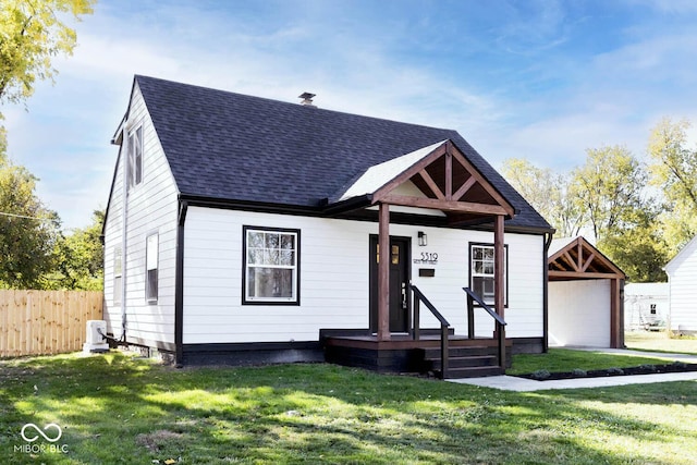 view of front of property with a front lawn, an outdoor structure, and a garage