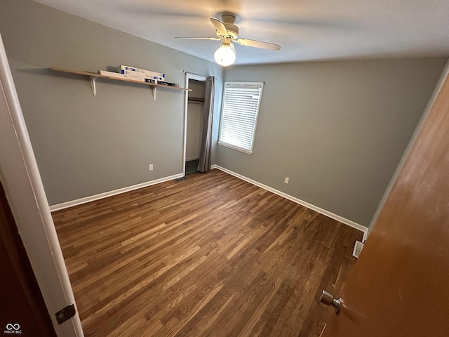 unfurnished bedroom with dark hardwood / wood-style floors and ceiling fan