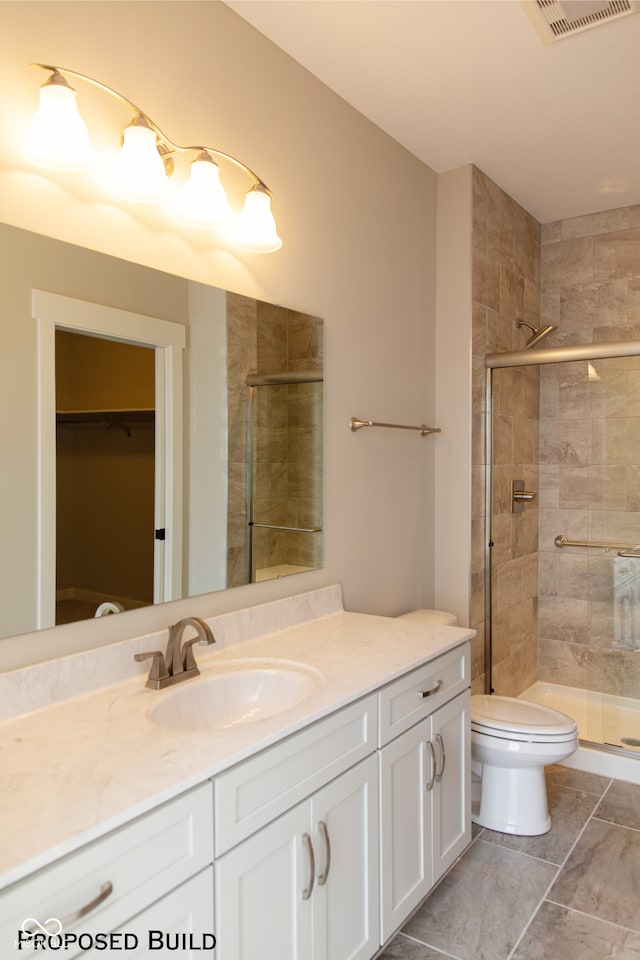 bathroom featuring vanity, toilet, and walk in shower