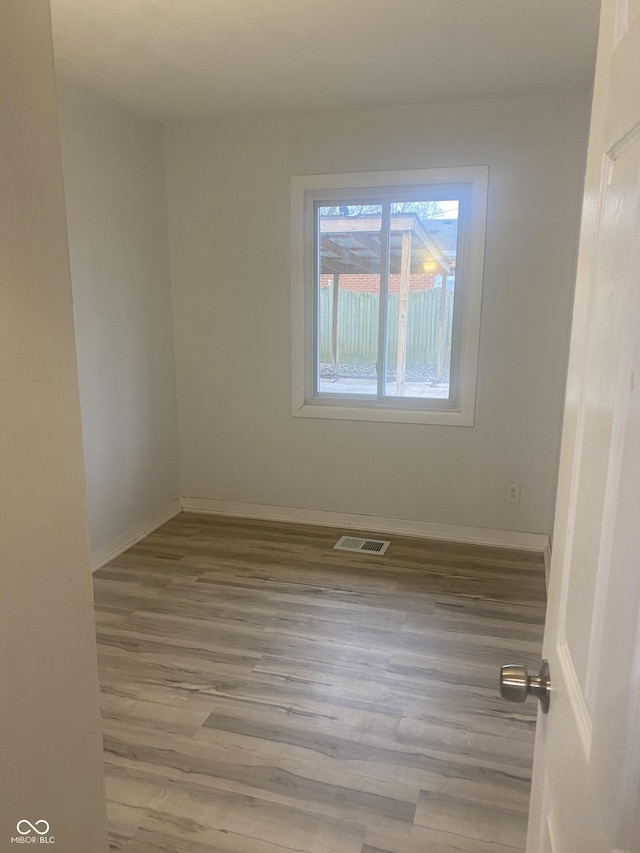 unfurnished room with light hardwood / wood-style floors