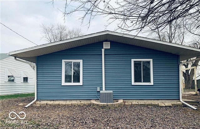 view of side of property featuring central air condition unit