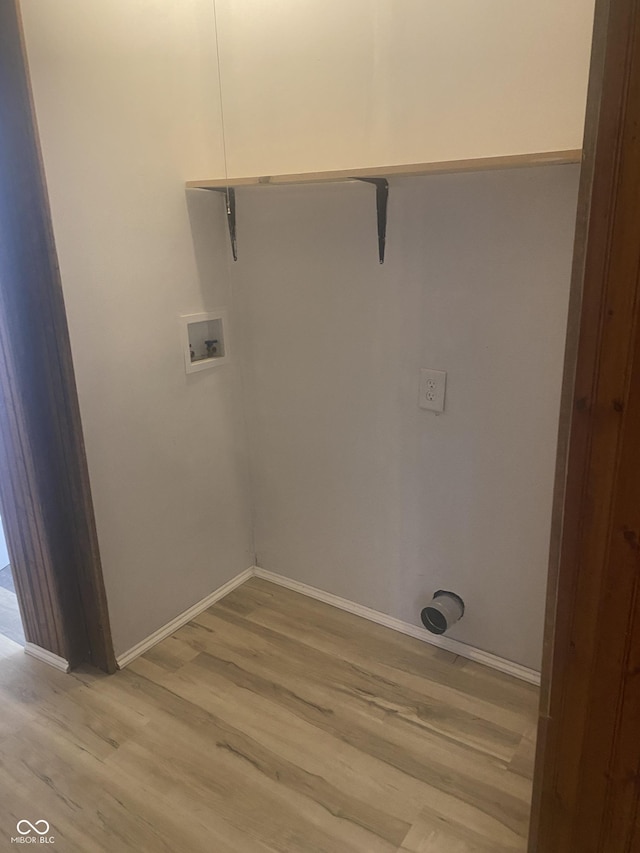 clothes washing area with washer hookup and light wood-type flooring