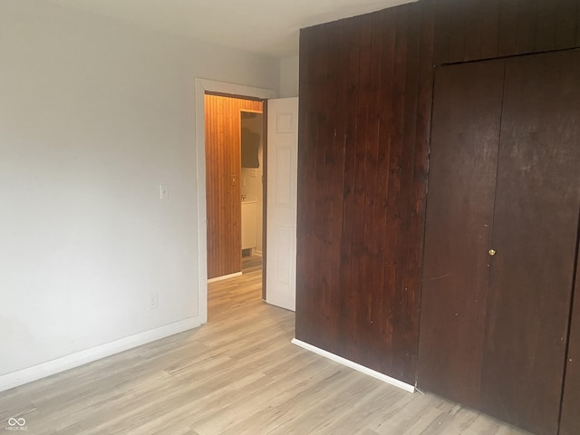 unfurnished bedroom with light hardwood / wood-style floors and a closet