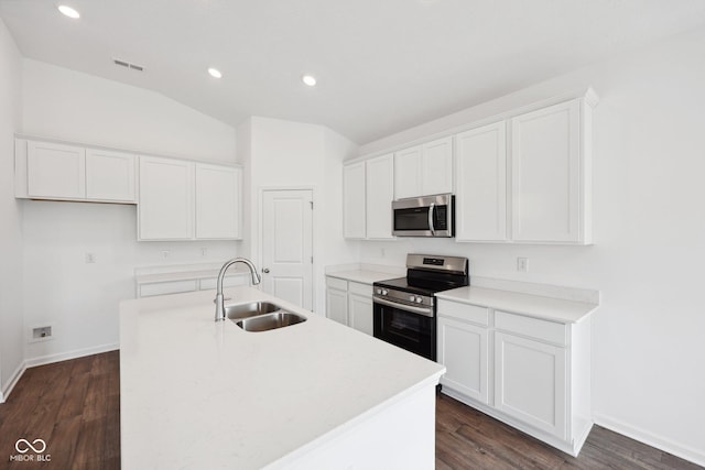 kitchen with appliances with stainless steel finishes, white cabinetry, an island with sink, and a sink