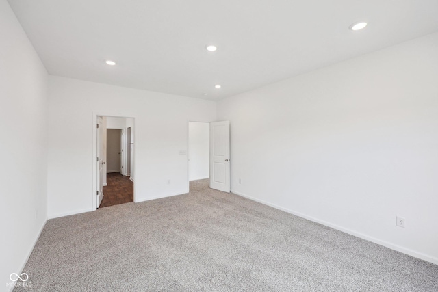 empty room with recessed lighting, baseboards, and carpet