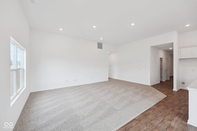 unfurnished room featuring dark wood-style floors, recessed lighting, visible vents, and baseboards