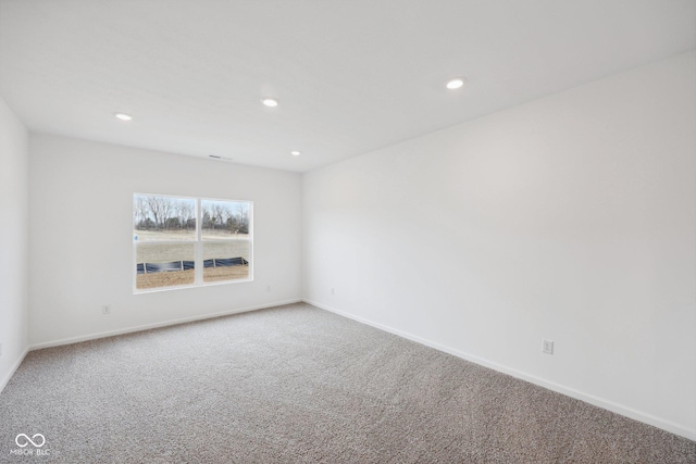 carpeted spare room featuring recessed lighting and baseboards