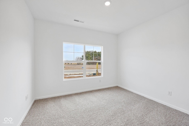 unfurnished room with recessed lighting, carpet, visible vents, and baseboards