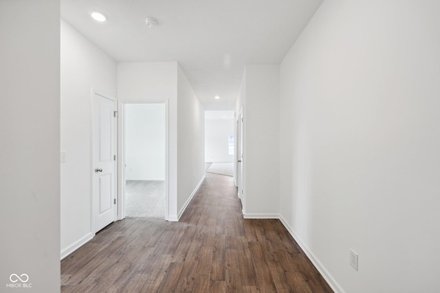 hallway with recessed lighting, baseboards, and wood finished floors