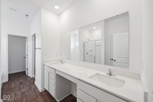 full bathroom with a sink, visible vents, a stall shower, and double vanity