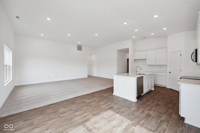 kitchen with visible vents, a sink, open floor plan, appliances with stainless steel finishes, and white cabinets