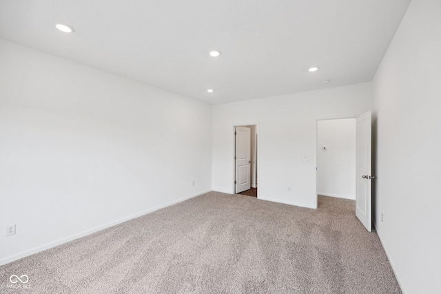 unfurnished bedroom featuring recessed lighting, baseboards, and carpet