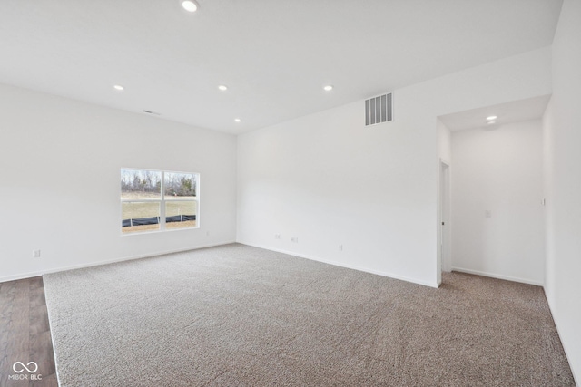 carpeted spare room with recessed lighting, visible vents, and baseboards