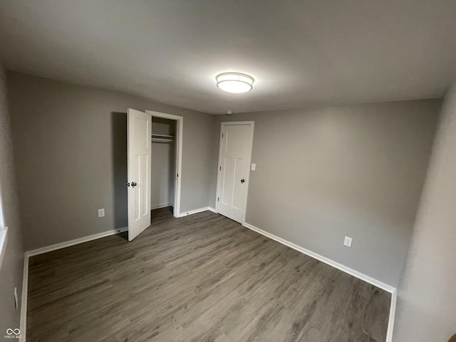 unfurnished bedroom with dark hardwood / wood-style floors