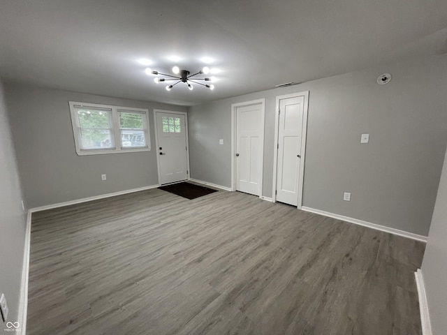 entryway featuring hardwood / wood-style floors and an inviting chandelier