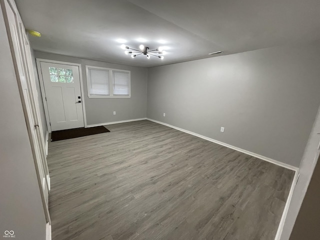 foyer with hardwood / wood-style flooring and a notable chandelier