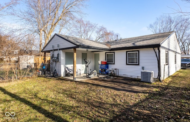 rear view of property featuring central air condition unit, a patio area, and a yard