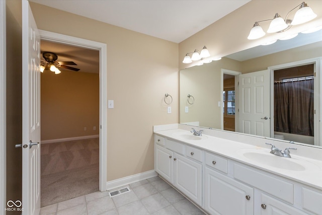 bathroom with ceiling fan and vanity