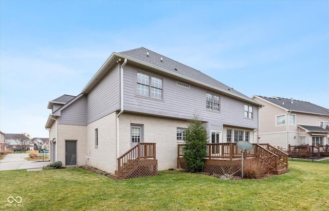 back of house with a yard and a wooden deck