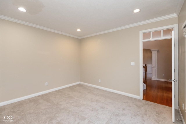 carpeted spare room featuring crown molding