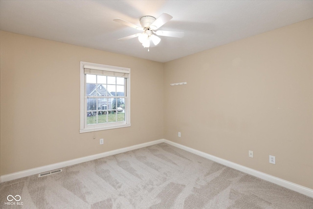 carpeted spare room with ceiling fan