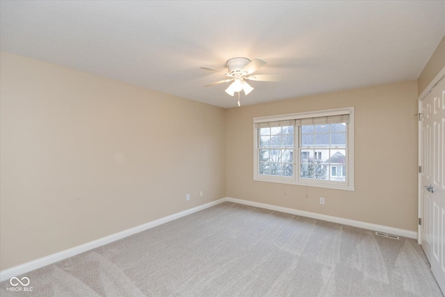 spare room with light carpet and ceiling fan