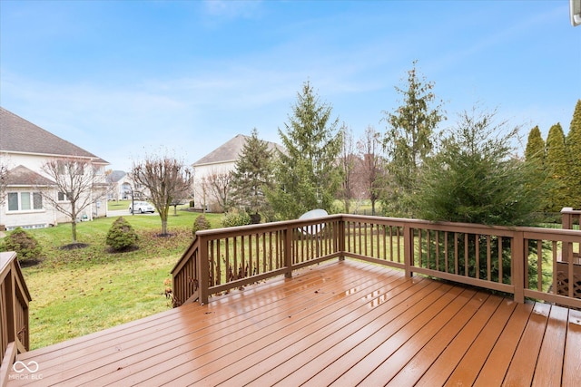 wooden deck with a lawn