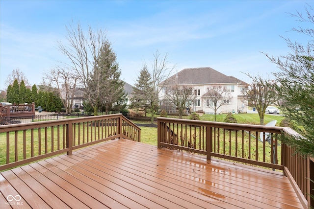 wooden deck featuring a yard