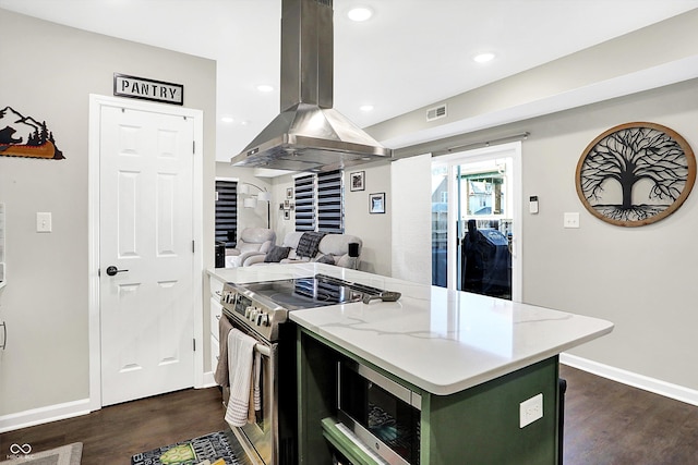 kitchen with island exhaust hood, dark wood-type flooring, a kitchen island, and stainless steel appliances