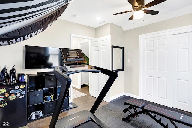 workout area with ceiling fan and hardwood / wood-style flooring