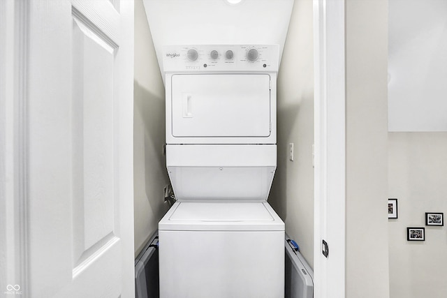 clothes washing area with stacked washer and dryer