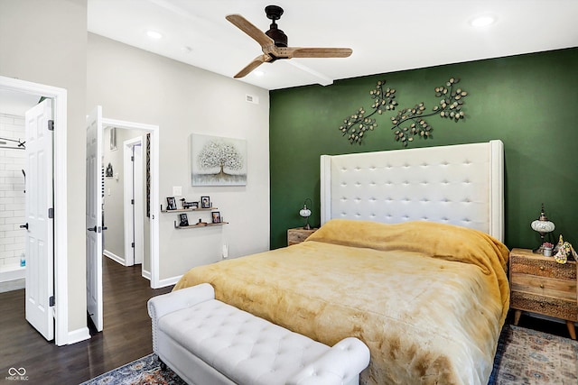 bedroom with ensuite bath, ceiling fan, and dark hardwood / wood-style floors