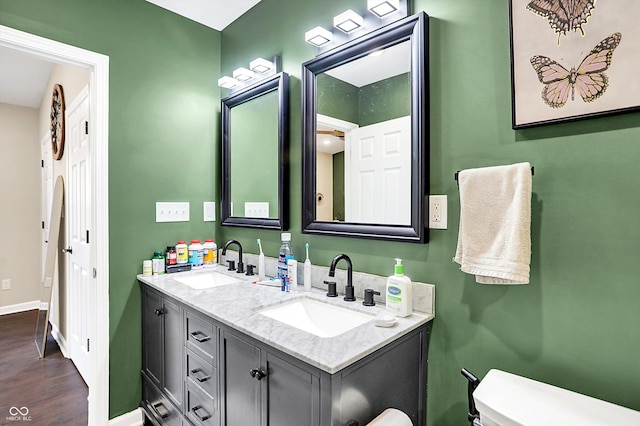 bathroom featuring hardwood / wood-style floors, vanity, and toilet