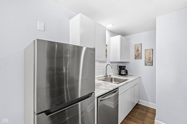 kitchen featuring sink, white cabinetry, stainless steel appliances, and tasteful backsplash