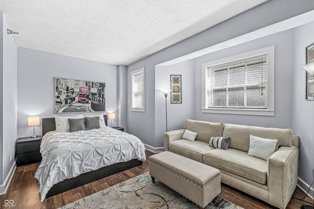 bedroom featuring dark hardwood / wood-style floors and a textured ceiling