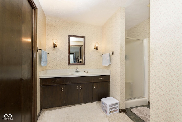 bathroom with tile patterned flooring, vanity, and walk in shower