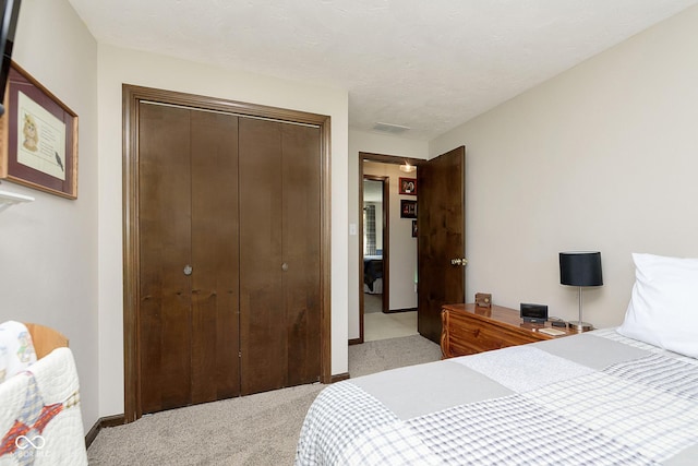 bedroom with light carpet and a closet