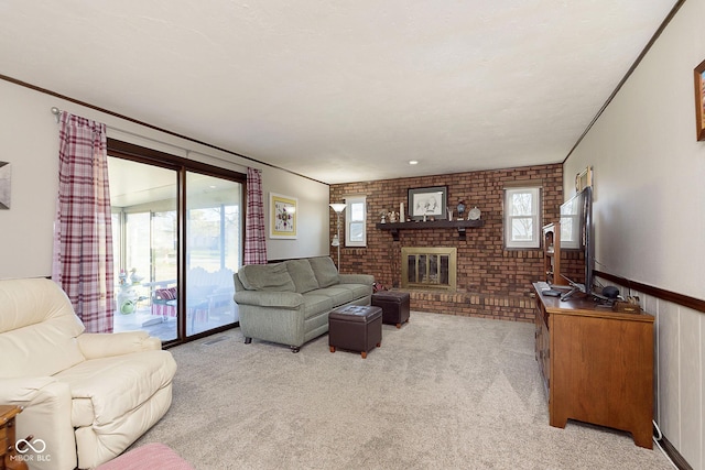 carpeted living room with ornamental molding, a fireplace, and brick wall