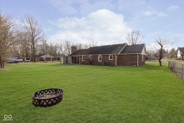 exterior space featuring a lawn, a sunroom, and cooling unit