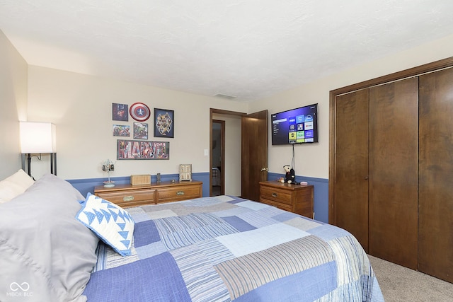 carpeted bedroom with a closet