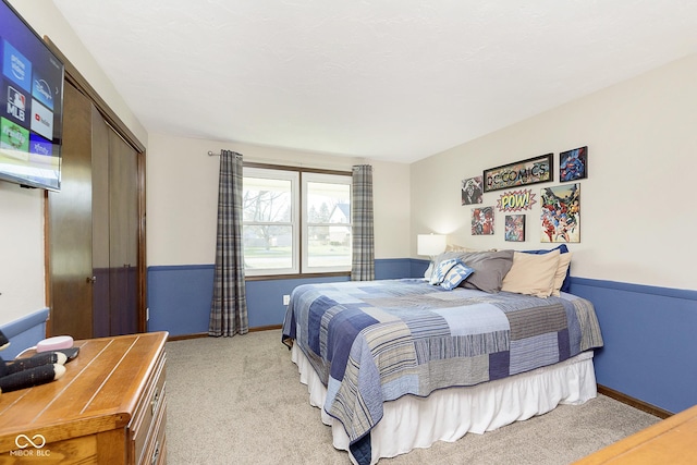 bedroom with a closet and light colored carpet