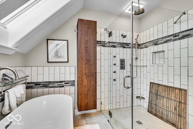 bathroom with shower with separate bathtub and tile patterned floors