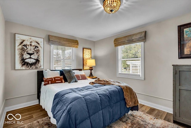 bedroom with dark wood-type flooring