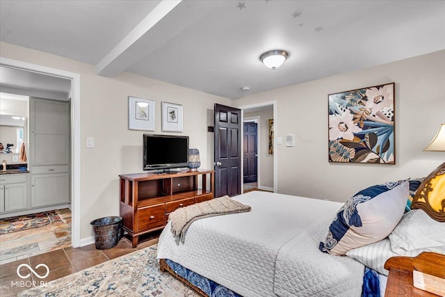 bedroom with beam ceiling and ensuite bath