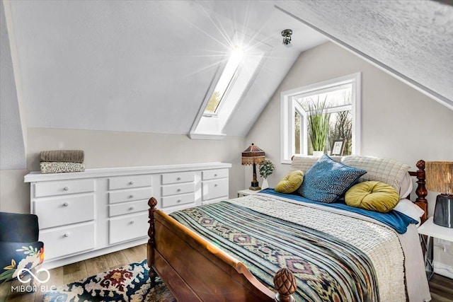 bedroom featuring hardwood / wood-style floors and vaulted ceiling