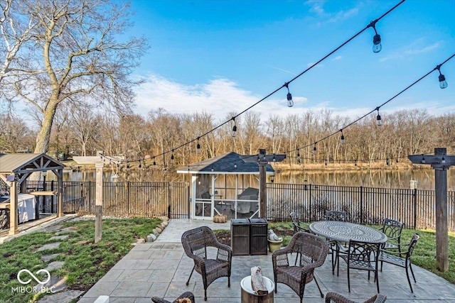 view of patio / terrace with a sunroom and a water view