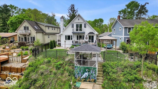 2222 E 75th St, Indianapolis, IN 46240 - rear view of house featuring a gazebo, a sunroom, a fenced backyard, and a patio area