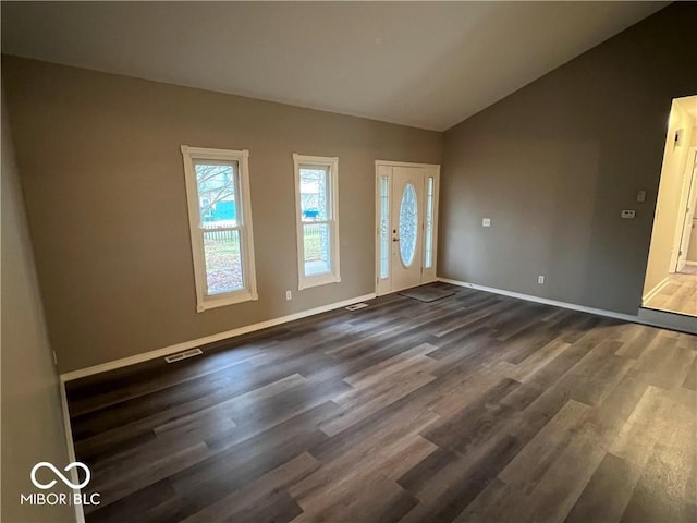 foyer with dark hardwood / wood-style flooring and lofted ceiling