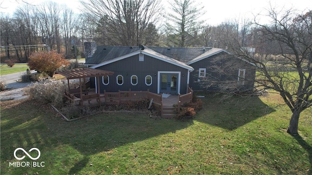 view of front of home with french doors, a front lawn, and a deck