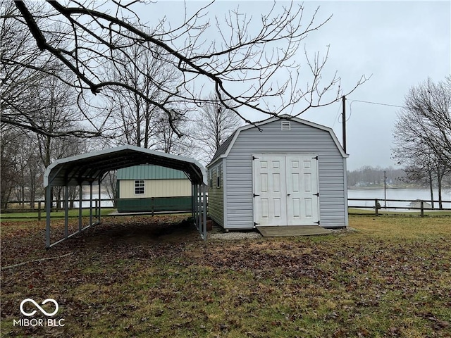 view of outdoor structure featuring a water view and a carport